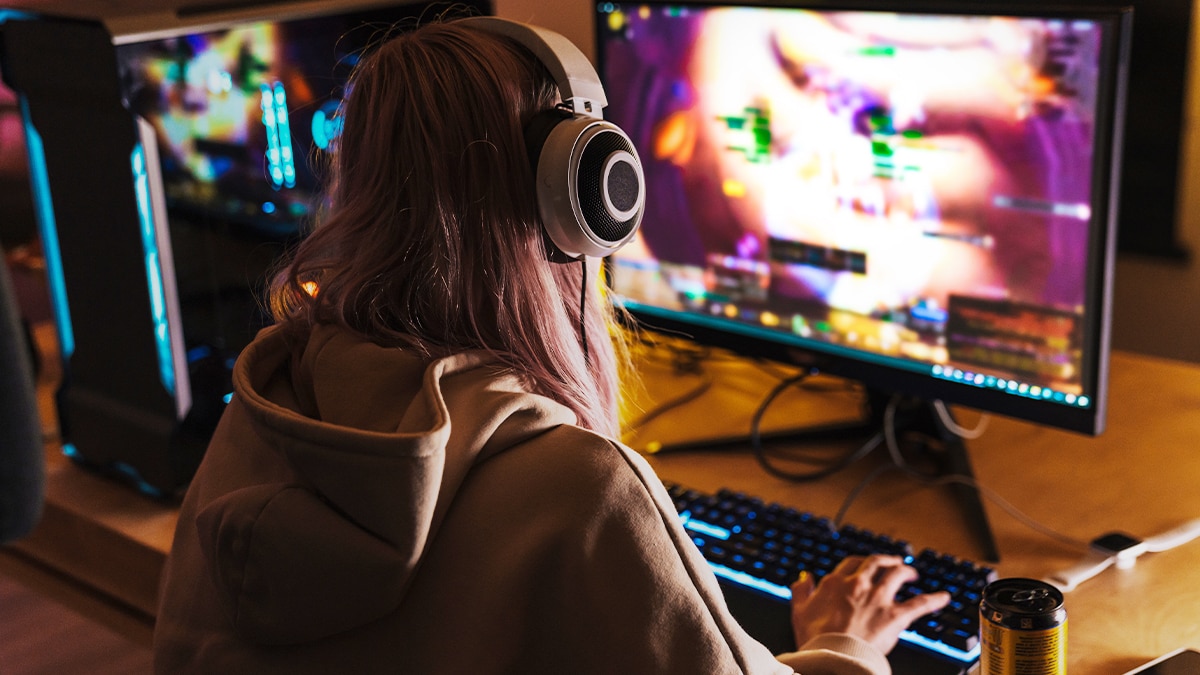 Person gaming at RGB-lit desktop PC